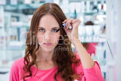 Pretty woman trying a mascara