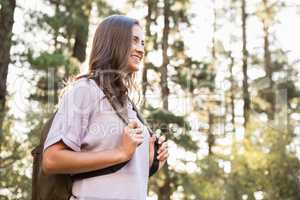 Pretty brunette hiker holding rucksack