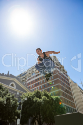 Athletic man doing parkour in the city