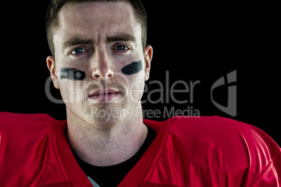 Smiling american football player looking at camera