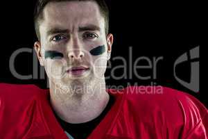 Smiling american football player looking at camera