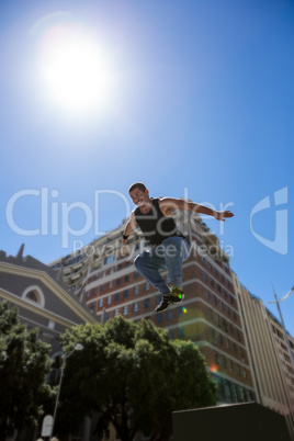 Athletic man doing parkour in the city