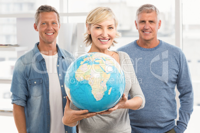 Smiling businesswoman holding terrestrial globe