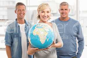 Smiling businesswoman holding terrestrial globe