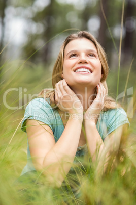 Young pretty hiker sitting in the high grass