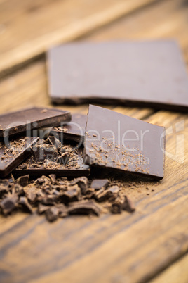 Pieces of chocolate on a wooden table