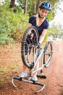 Athletic blonde checking her mountain bike