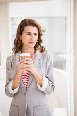 Casual businesswoman holding take-away cup