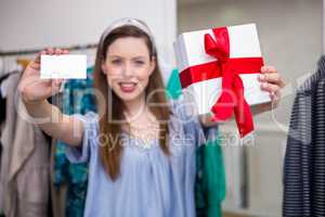 Brunette showing gift and card to camera