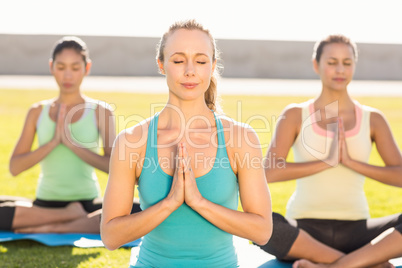 Peaceful sporty women doing lotus pose