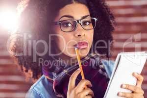 Attractive focused hipster taking notes