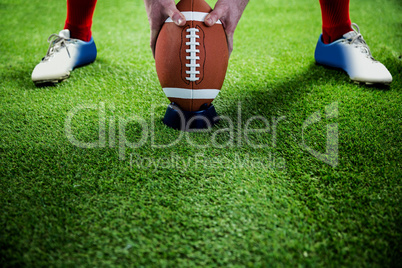 American football player preparing for a drop kick