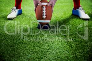 American football player preparing for a drop kick