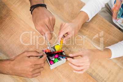 Casual business colleagues sorting pens