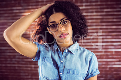 Attractive hipster holding hair back