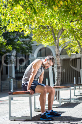 Exhausted athlete resting on a bench