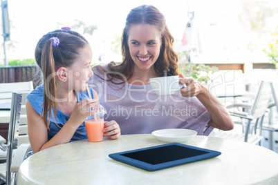 Mother and daughter at cafe terrace