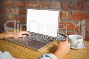 Woman doing online shopping and holding credit card