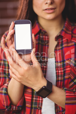 Pretty hipster showing her smartphone