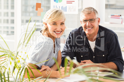 Smiling business team looking at the camera