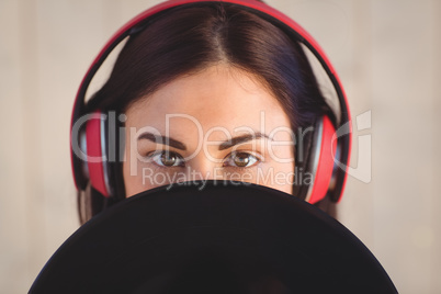 Pretty hipster listening to music holding vinyl