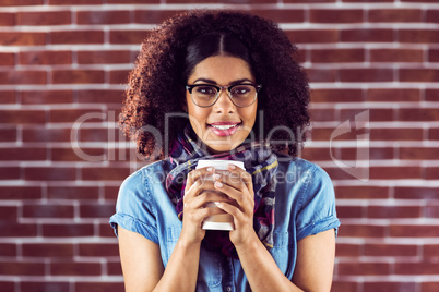 Smiling attractive hipster with take-away cup