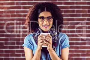 Smiling attractive hipster with take-away cup