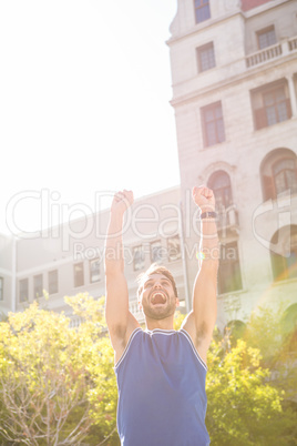 Happy handsome athlete triumphing