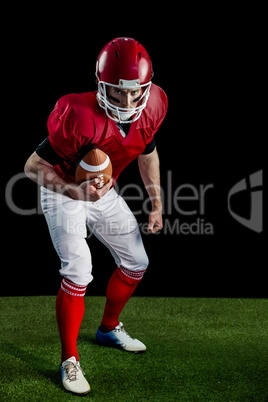 Portrait of focused american football player being ready to atta