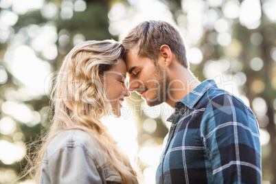 Happy young camper couple touching foreheads