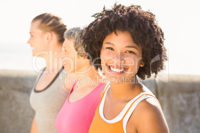 Smiling sporty woman with two friends