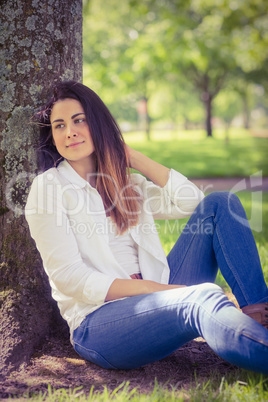 Beautiful brunette relaxing in the park