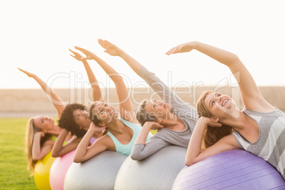 Smiling sporty women working out with exercise balls