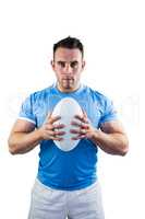 Rugby player looking at camera with ball