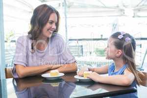 Mother and daughter enjoying cakes