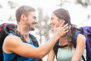 Young happy joggers looking at each other