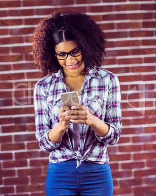 Smiling attractive hipster texting