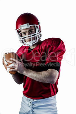 Portrait of american football player being about to throw footba