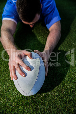 A rugby player scoring a try