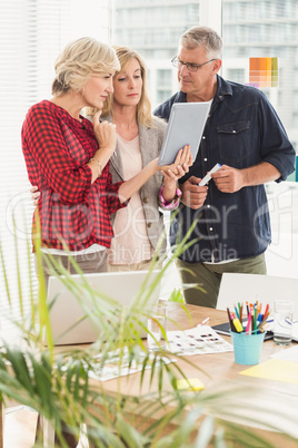 Attentive business team looking at digital tablet