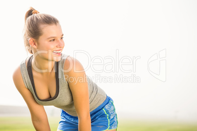 Smiling sporty blonde resting