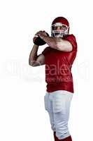 American football player throwing ball