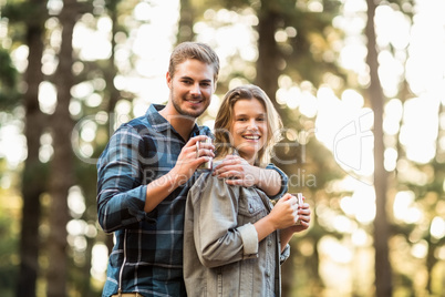 Happy smiling couple standing behind each other