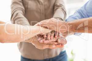 Business colleagues stacking hands together