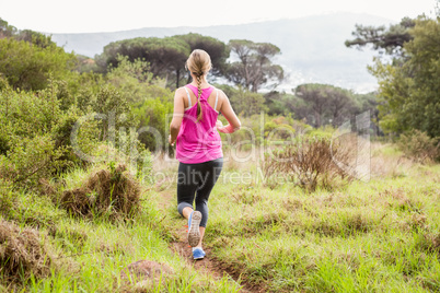 Pretty blonde athlete jogging