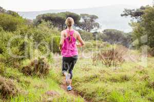 Pretty blonde athlete jogging