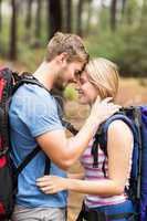 Young happy hiker couple touching foreheads