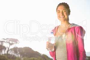 Fit woman drinking water from bottle