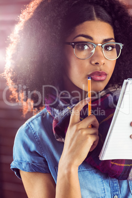 Attractive focused hipster taking notes