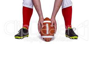 American football player placing the ball